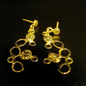 Gold earrings.